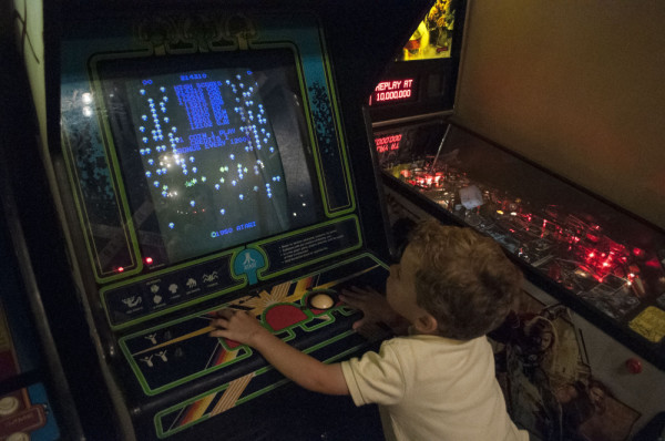 Child playing arcade game