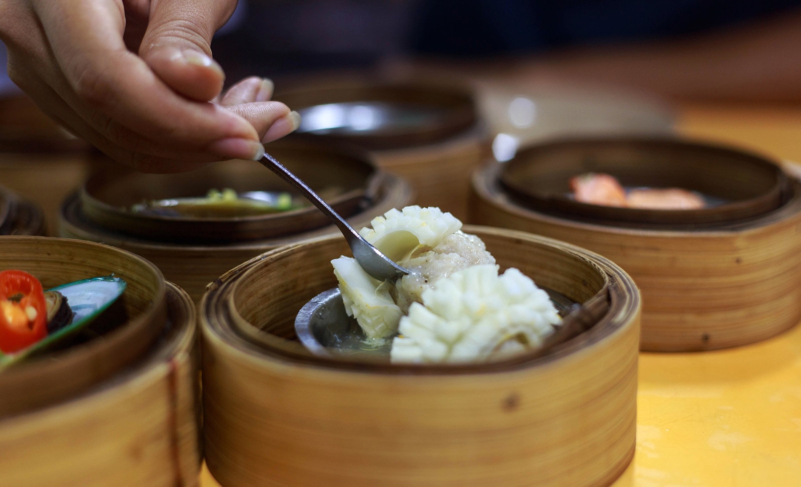 Someone eating dim sum.