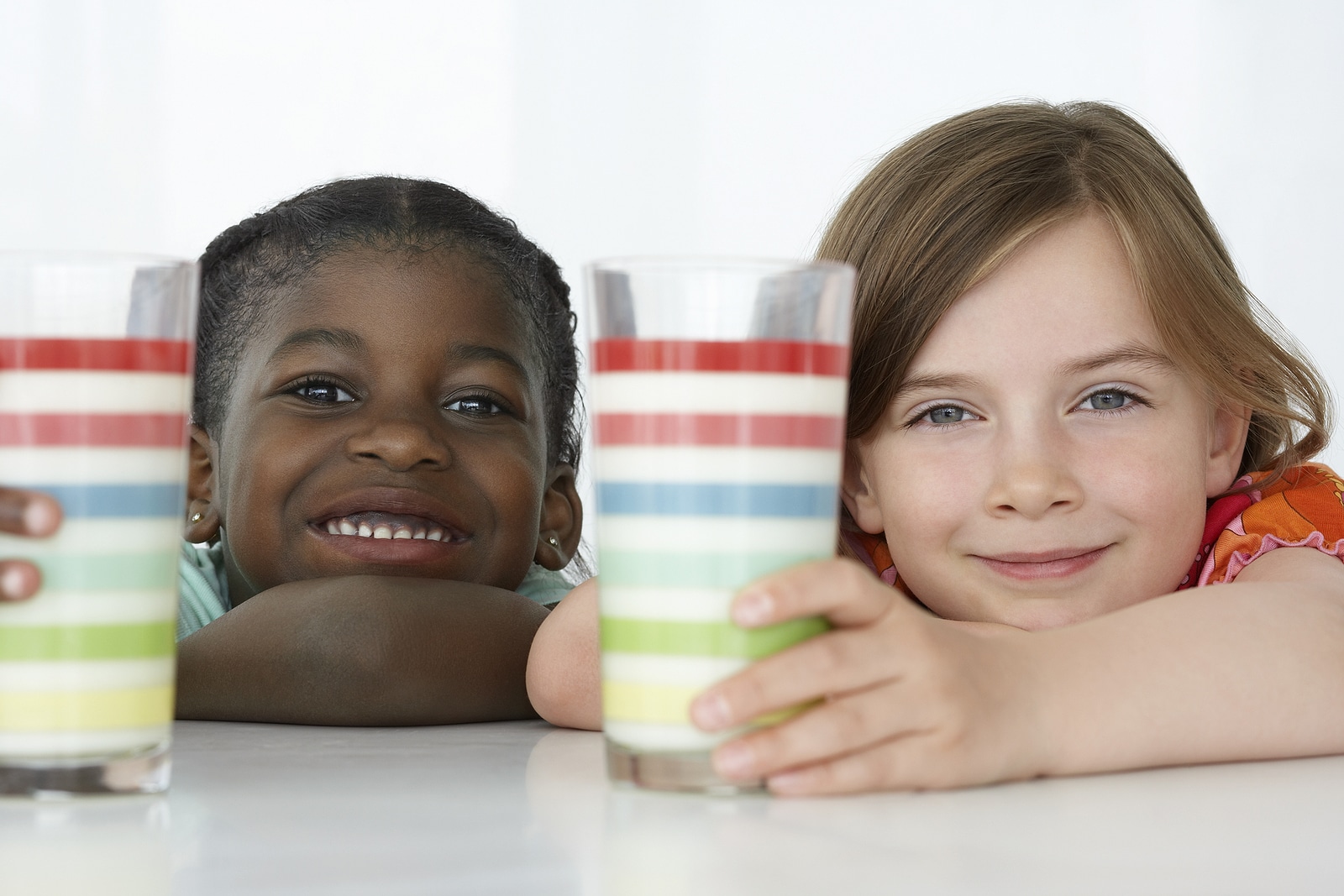 Kids with milk in glasses.