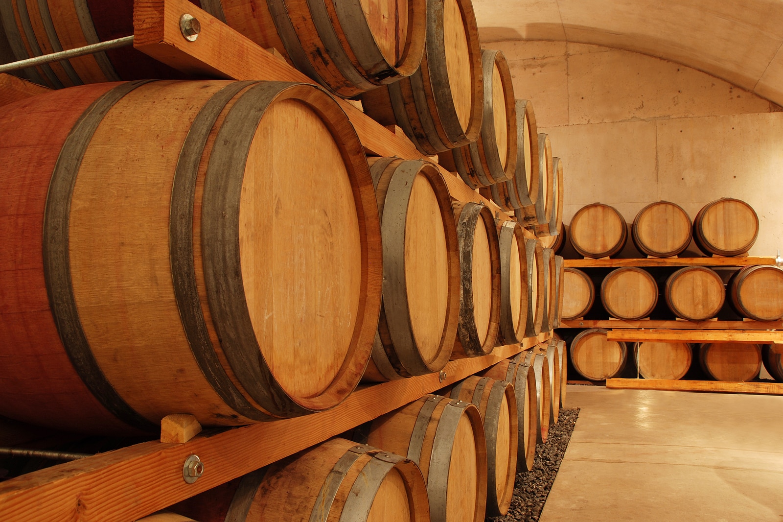 Row of wine barrels in an old cellar.