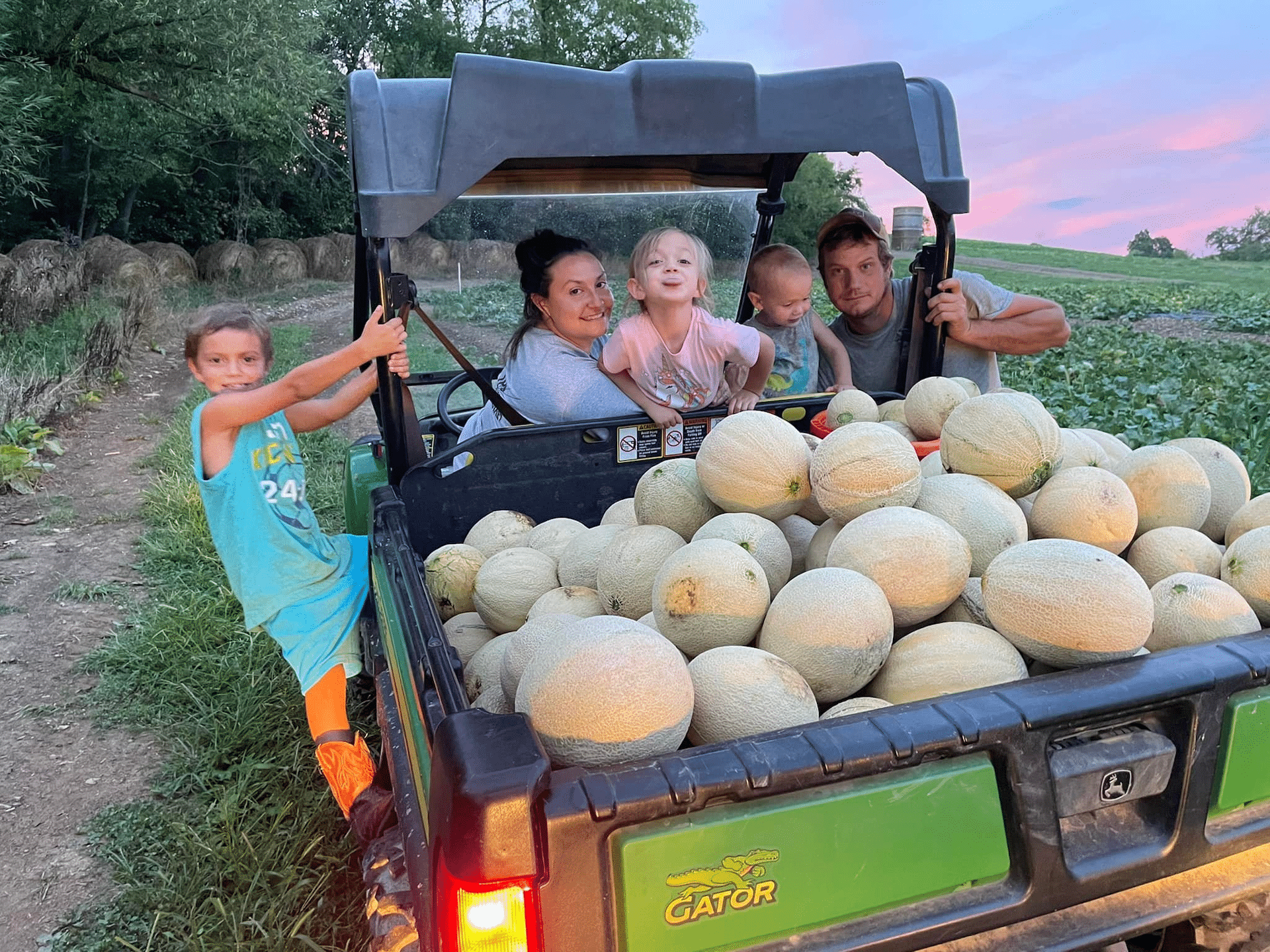 The family of PA Preferred JP's Farmers Market harvesting melons.