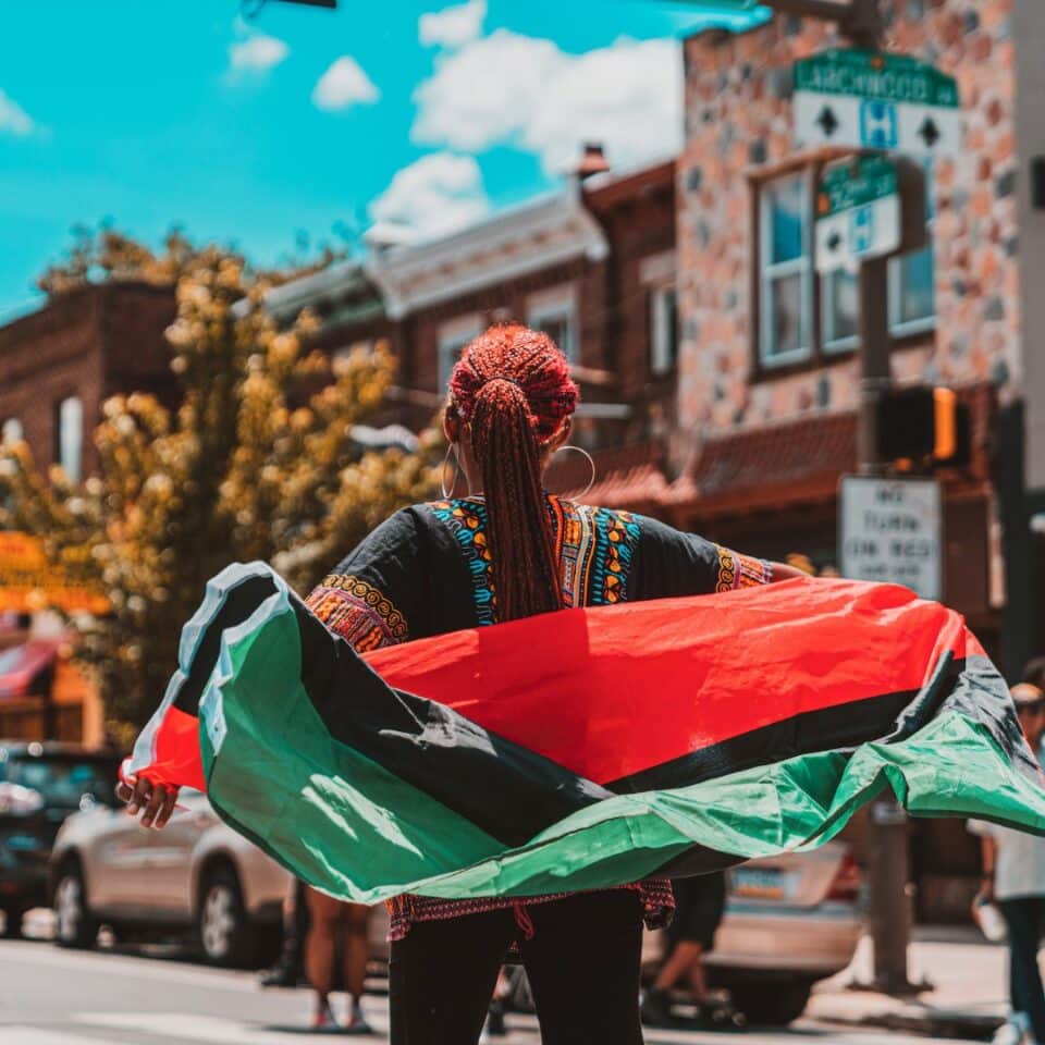 A woman with a flag during the Philadelphia Juneteenth Parade & Festival.