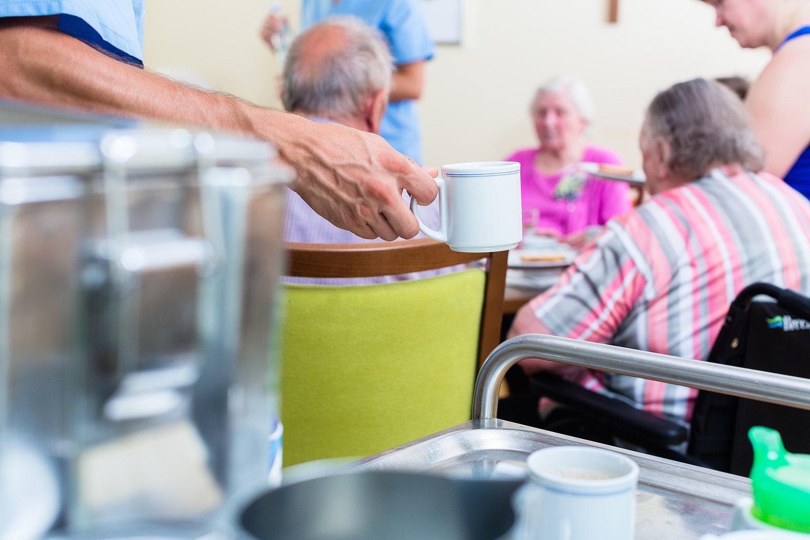 Nurse serving food in nursing home.