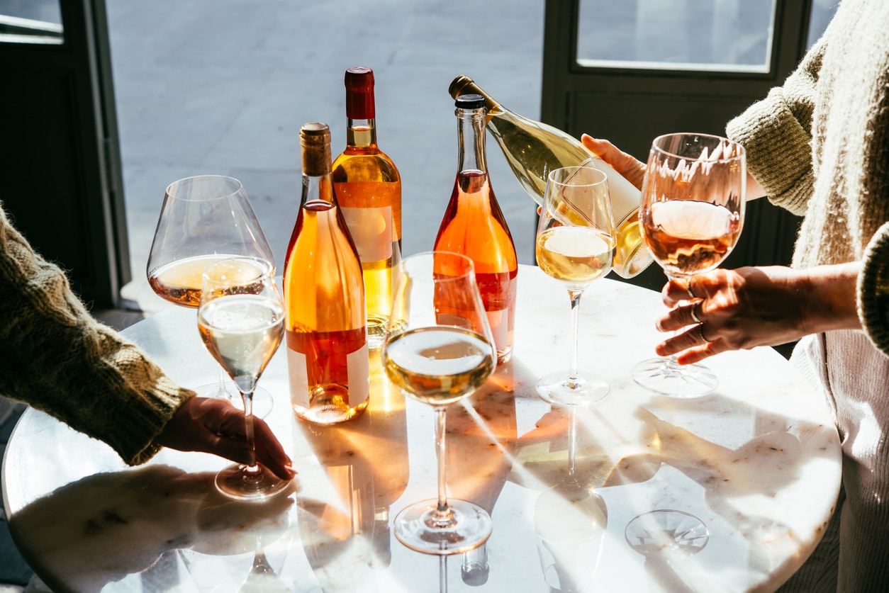 Different types of wine in glasses - red, white, rose and amber. Wine tasting in a bar or restaurant.