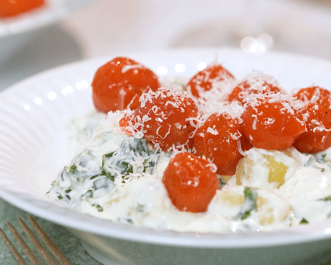 Spinach gnocchi with roasted tomatoes.