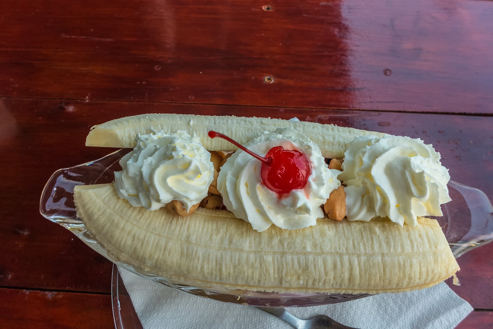 A delicious banana split with whipped cream.