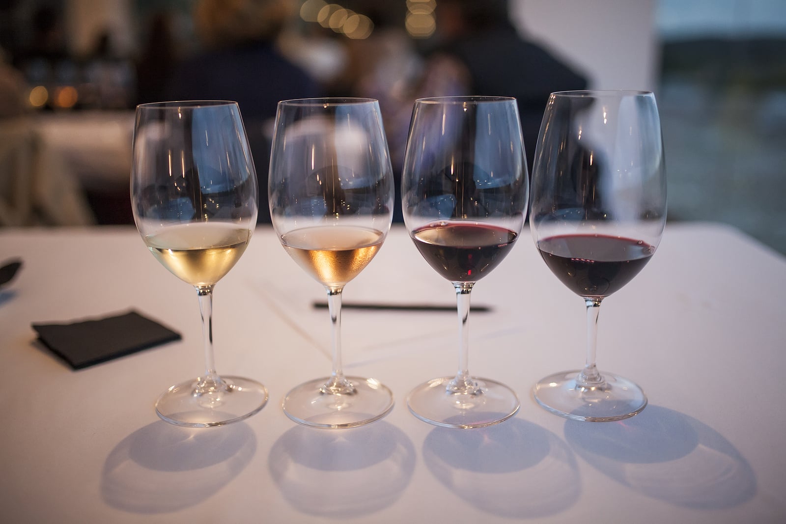 Four glasses of wine at a tasting.