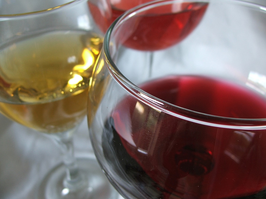 Abstract close up of wine varities, focus on red wineglass rim.