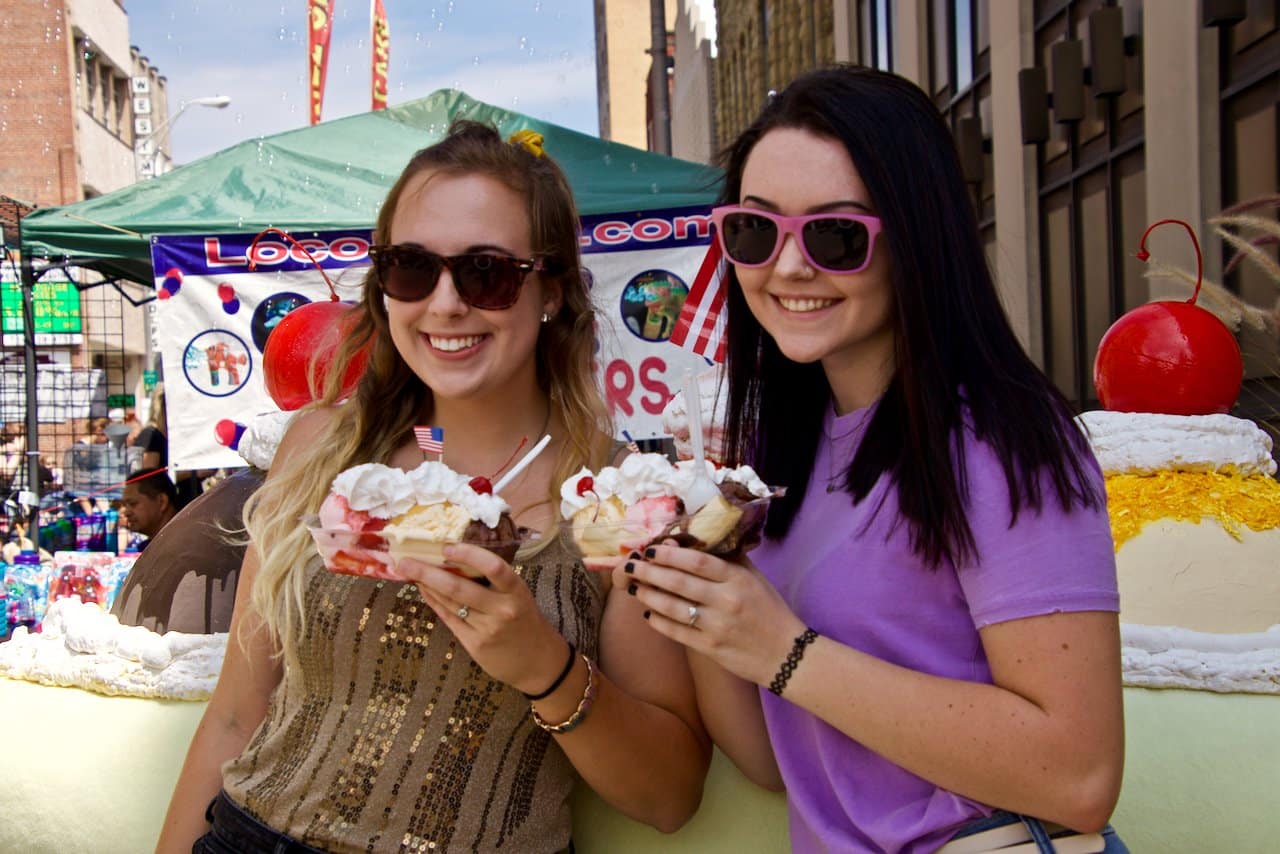 Women holding banana splits.