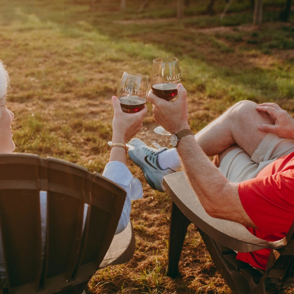 Red wine cheers at Waltz Vineyards Estate Winery.