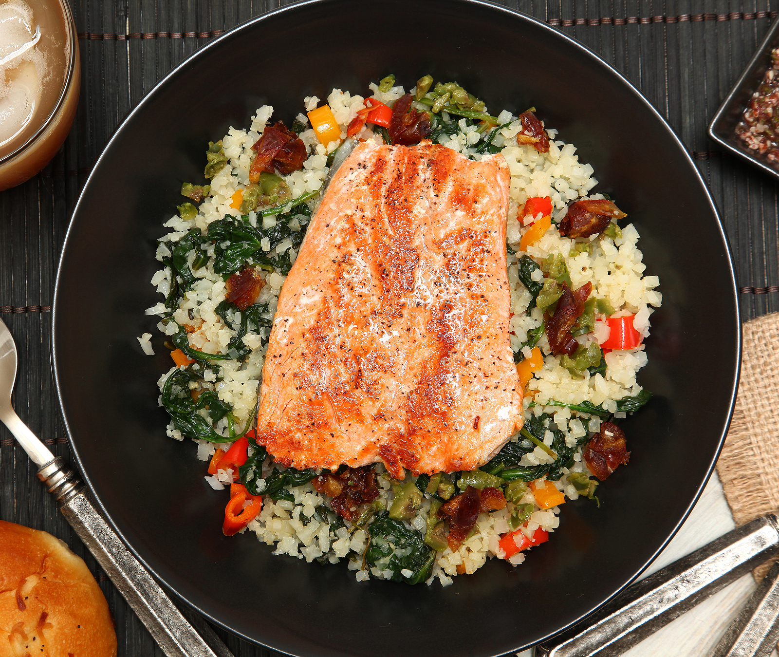 Salmon with Riced Cauliflower and Vegetable Salad at table.