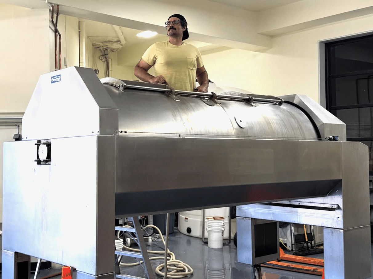 Tom Caruso cleaning a wine tank.