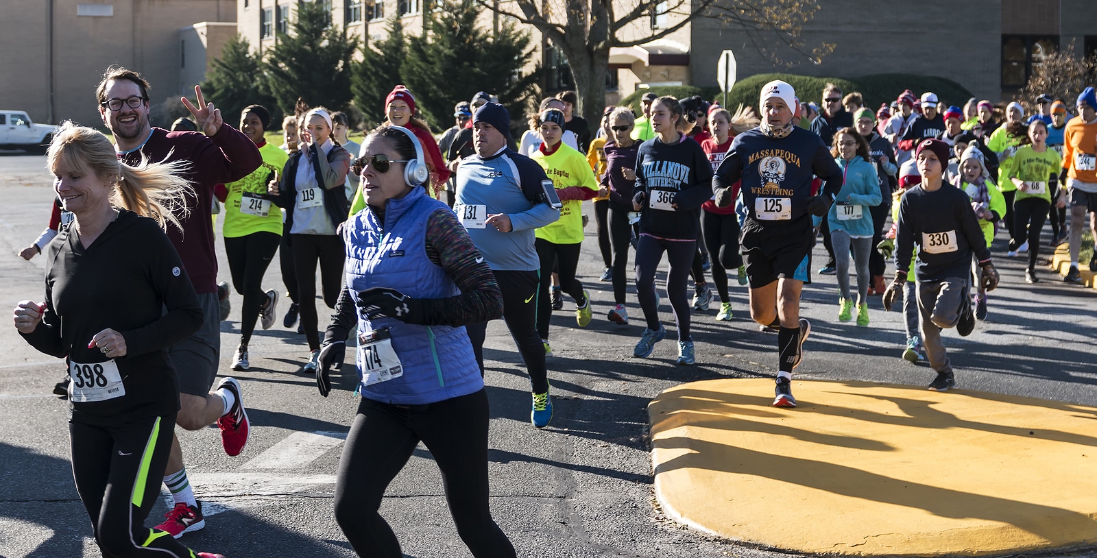 West Islip NY USA - 24 November 2017: The middle of the pack of a group of runners racing a local turkey trot on Thanksgiving weekend.