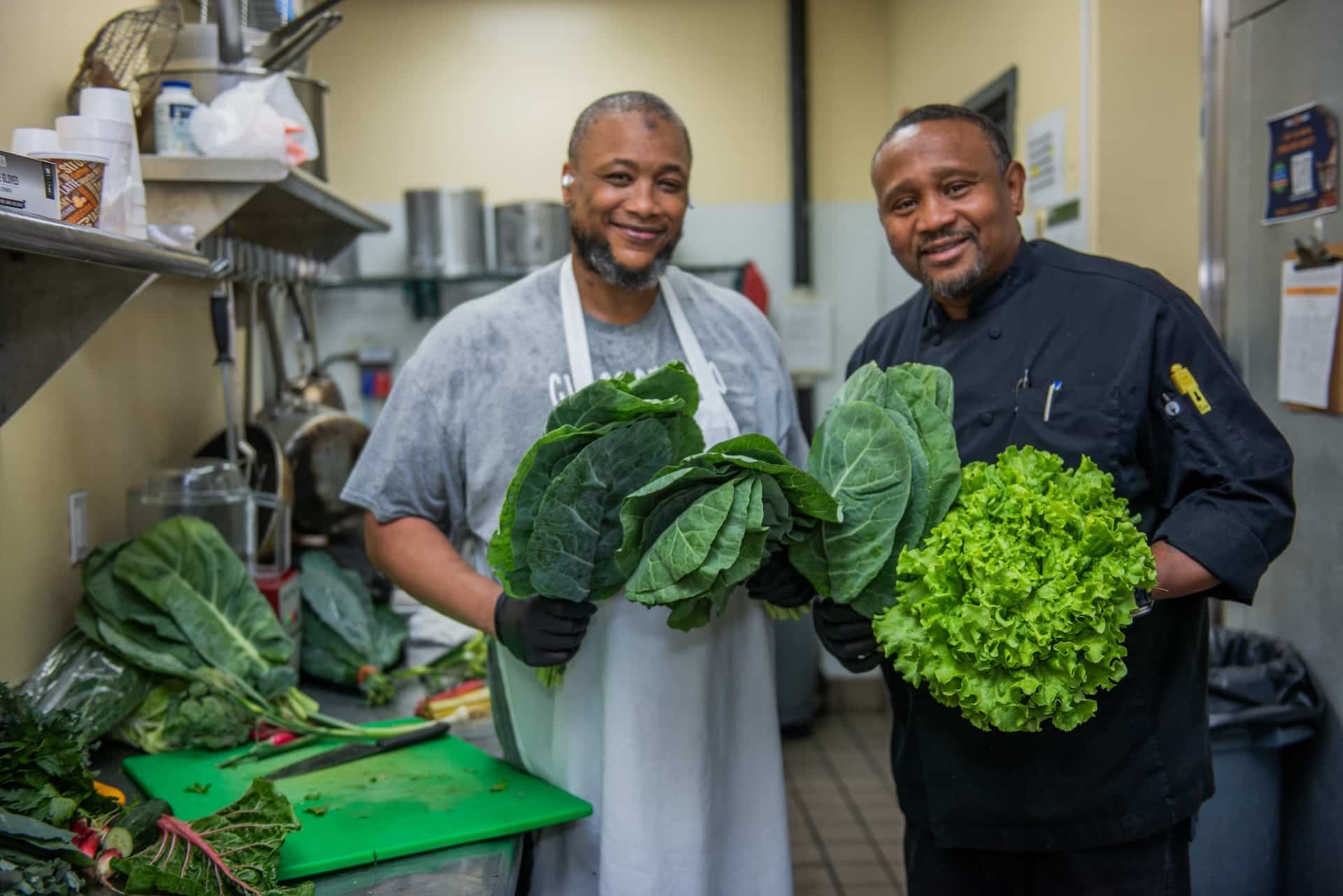 Chef Andrew Neal and coworker of Philly House with fresh produce.