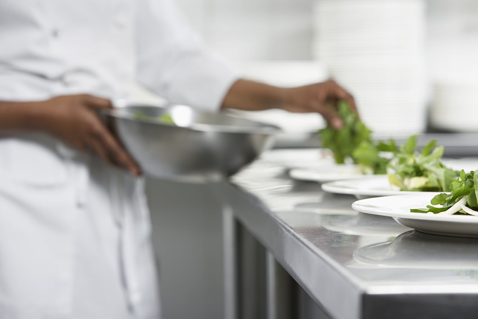 Closeup of a chef preparing food for a catered event.