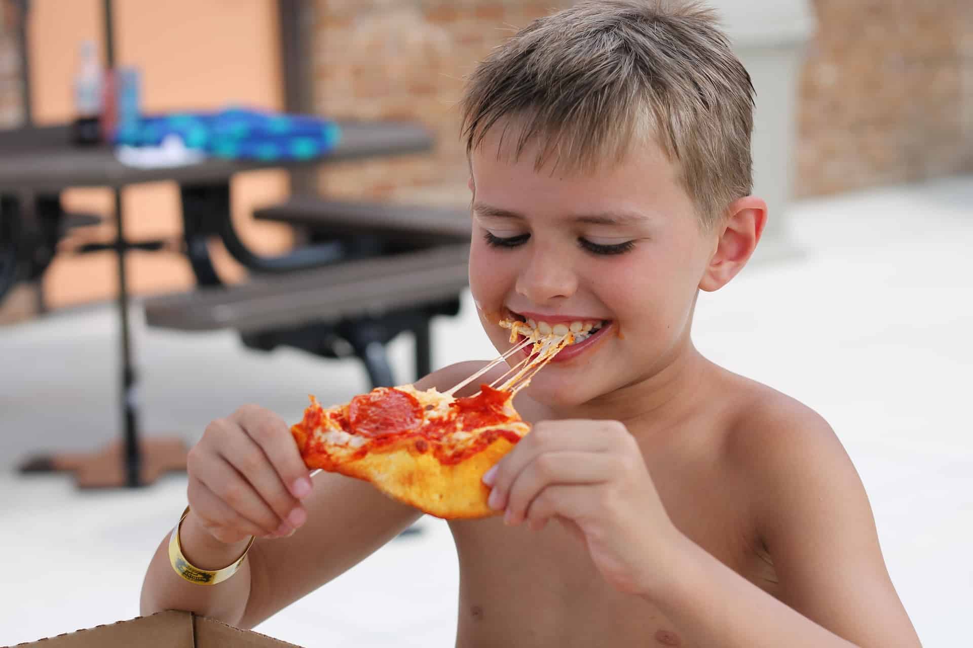 Boy eating pizza at DelGrosso's Amusement Park.