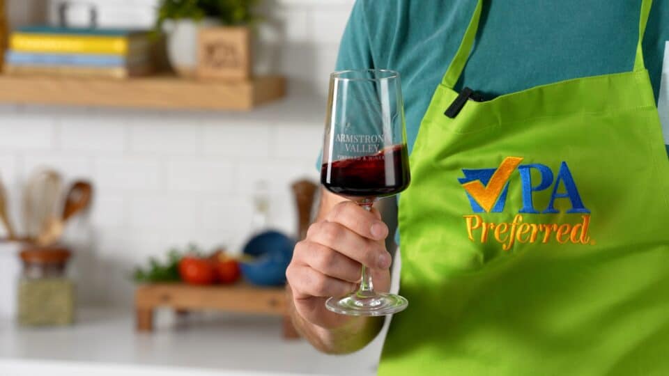 Caleb Wright holds Armstrong Valley Winery red wine.