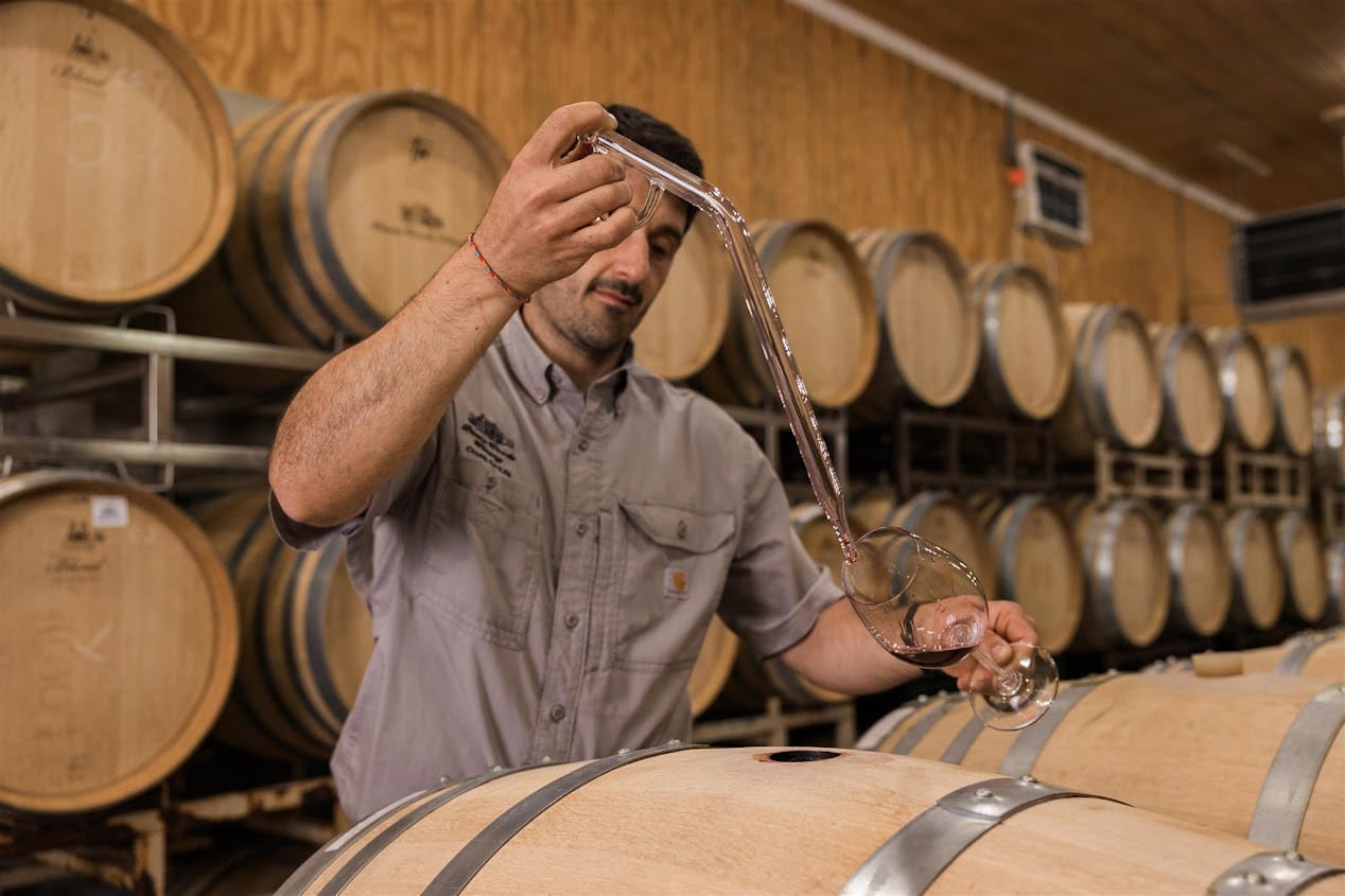 Davide Creato pulling a barrel sample at Penns Woods Winery.